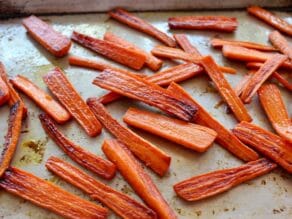 Roasted carrots on baking sheet.