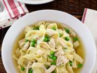 A delicious bowl of homemade chicken and noodles, served in a savory broth