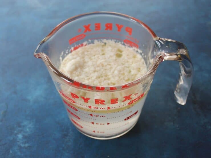Foam skimmed from stock into glass measuring cup, 2 cups of liquid.