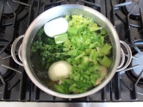 Pot full of ingredients and water for chicken stock.