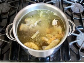 Bringing chicken stock with roast chicken carcass to a simmer, not much foam.