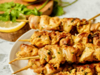 Skewered chicken with tangy lemon marinade on a plate