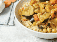 Colorful Moroccan vegetable couscous dish with a blend of spices and herbs, served in traditional style