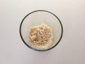 Overhead shot of crumble topping mixture in a mixing bowl.
