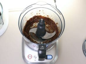 Food processor filled with date filling mixture.