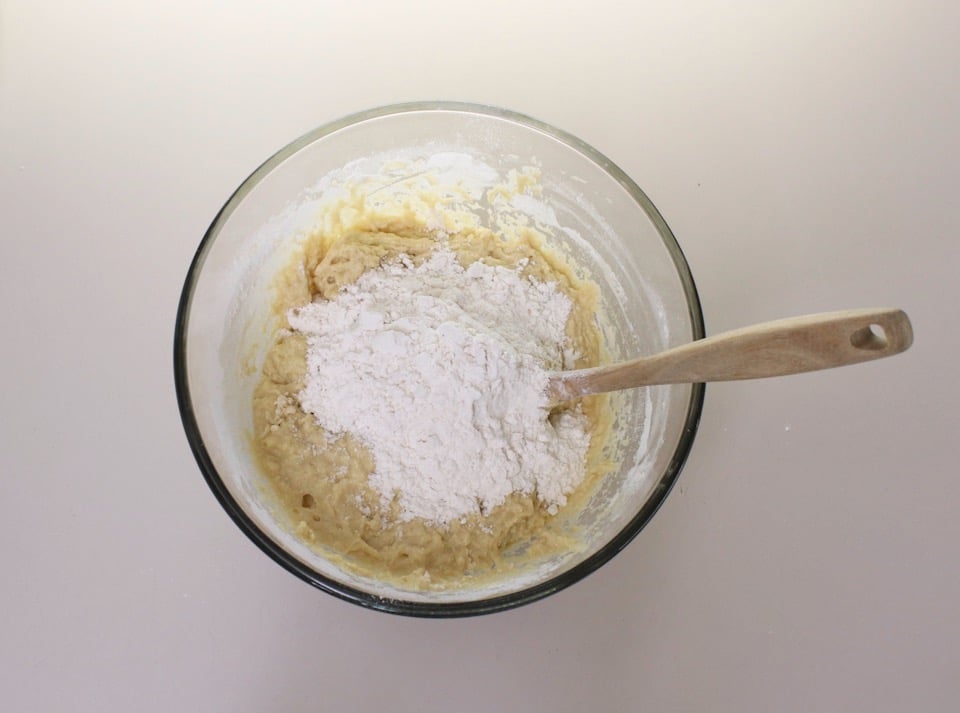 Overhead shot of mixing bowl filled with dough and flour.